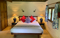 Double bed with red cushions